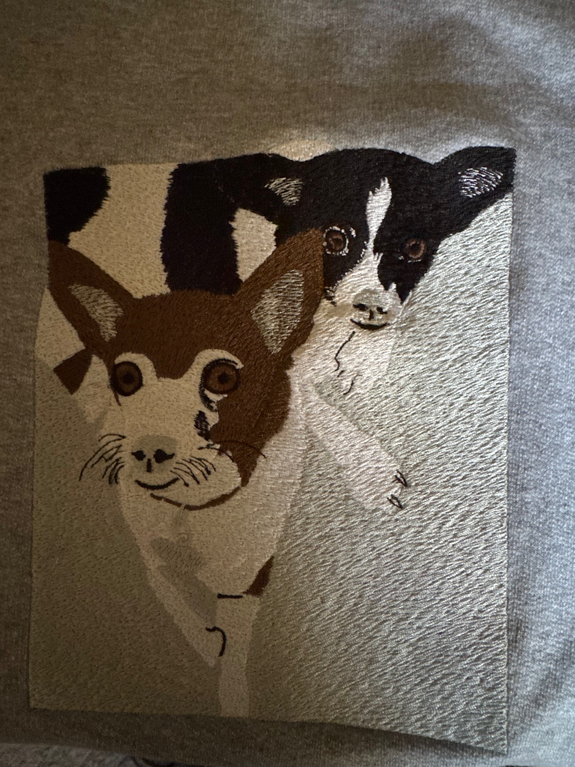 Custom embroidered gray sweatshirt featuring a detailed black-and-white dog design, created by a Minnesota-based embroidery shop with nationwide shipping.